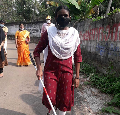 Battle for Blindness NGO girl is walking with the help of stick.