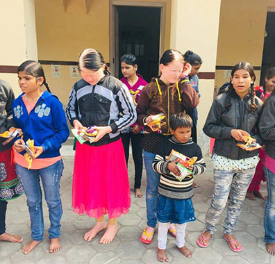 Battle for Blindness NGO girls stands with refreshments.