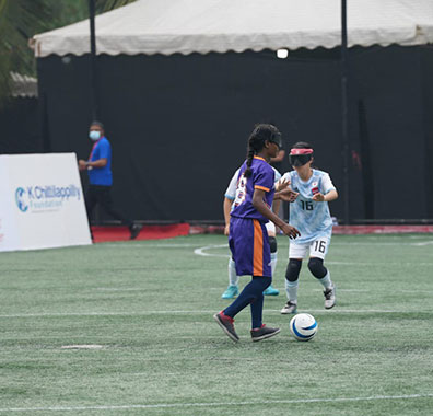 Battle for Blindness NGO, visually impaired girls playing football on the playground.